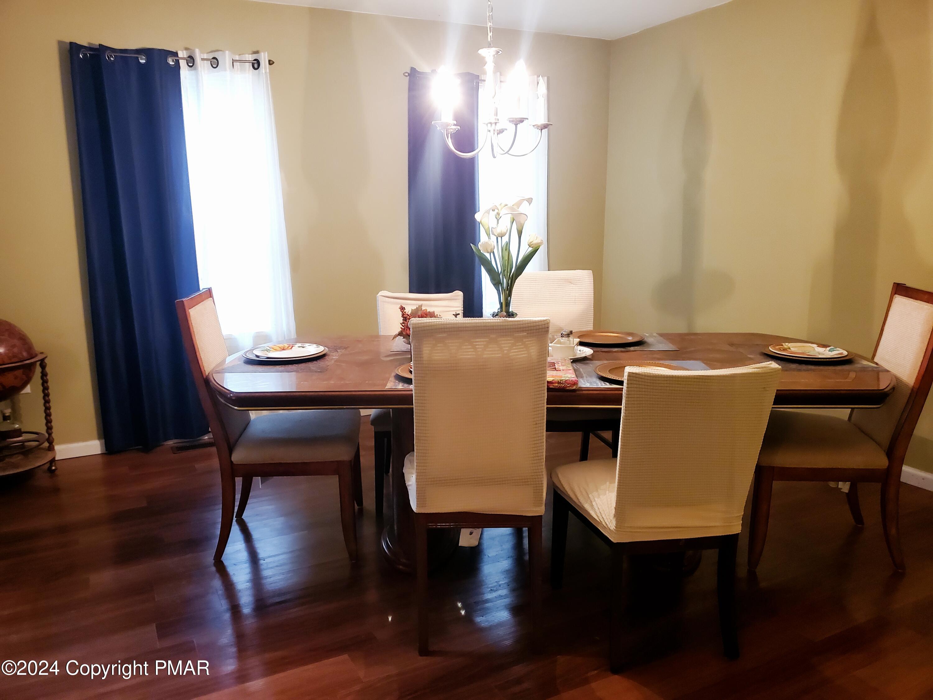 1102 Steele Circle Bushkill, PA 18324 - Photo 16 of 23 a view of a dining room with furniture and wooden floor