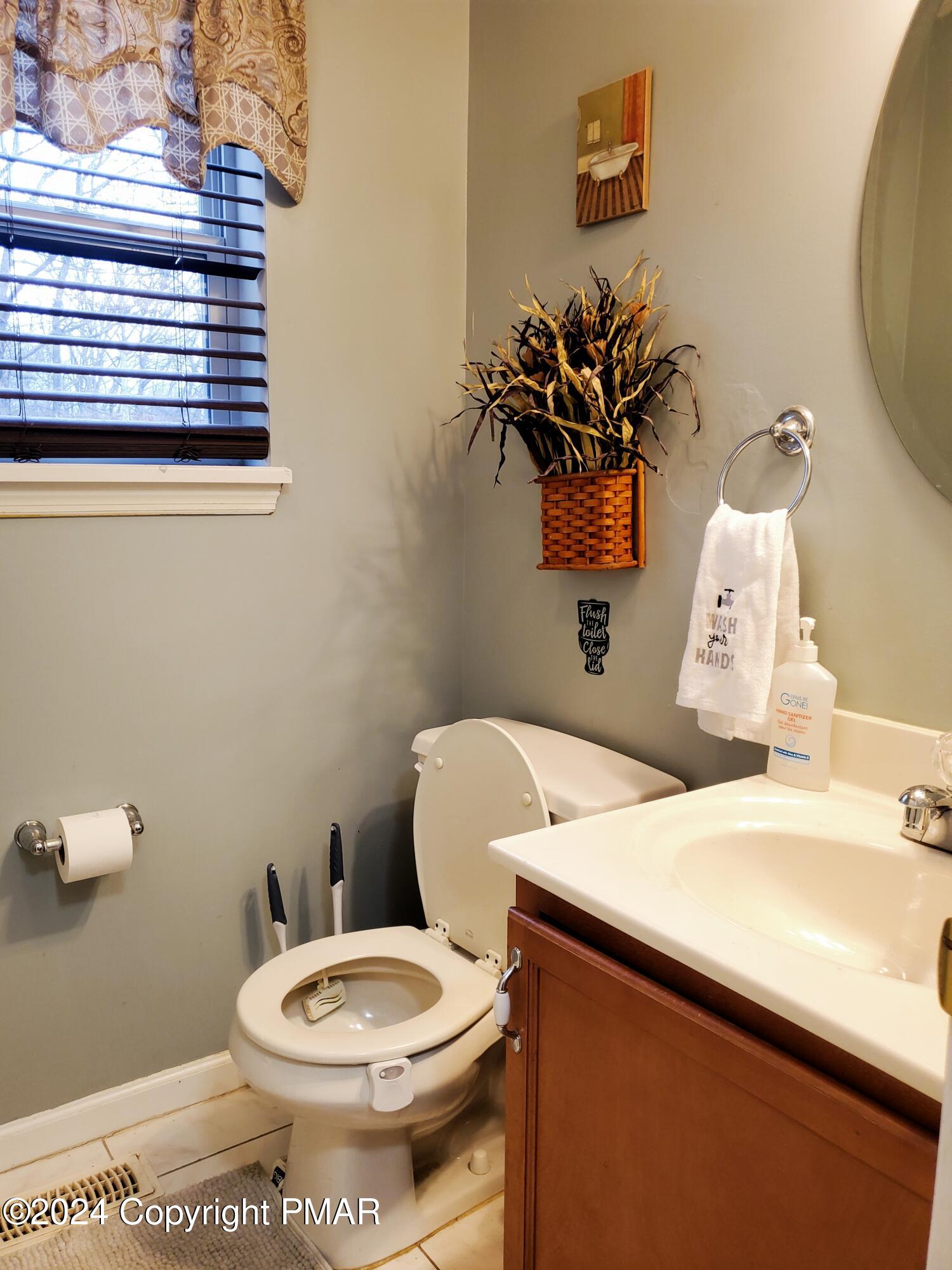 1102 Steele Circle Bushkill, PA 18324 - Photo 17 of 23 a white toilet sitting next to a bathroom sink
