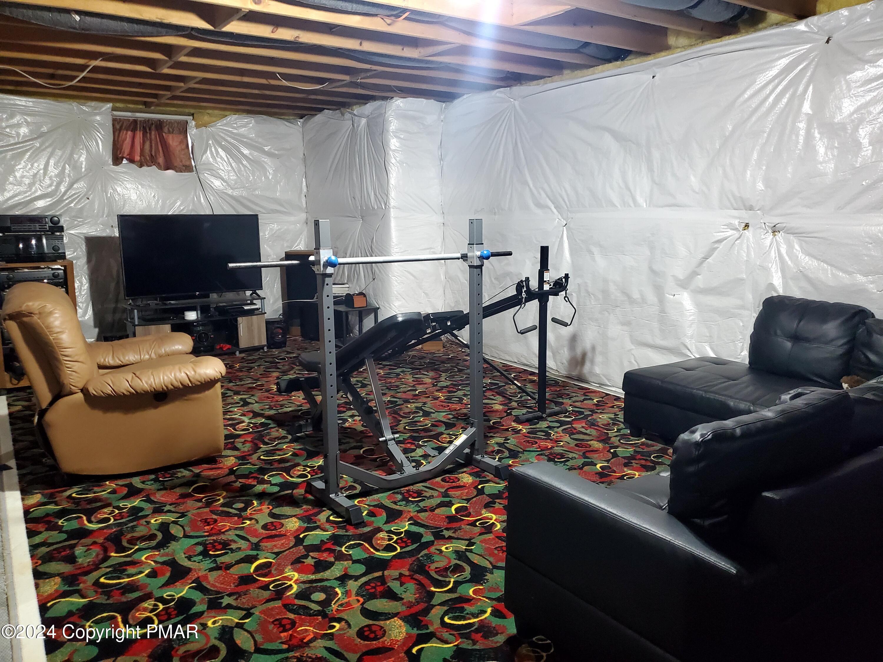 1102 Steele Circle Bushkill, PA 18324 - Photo 19 of 23 a living room with furniture and a flat screen tv