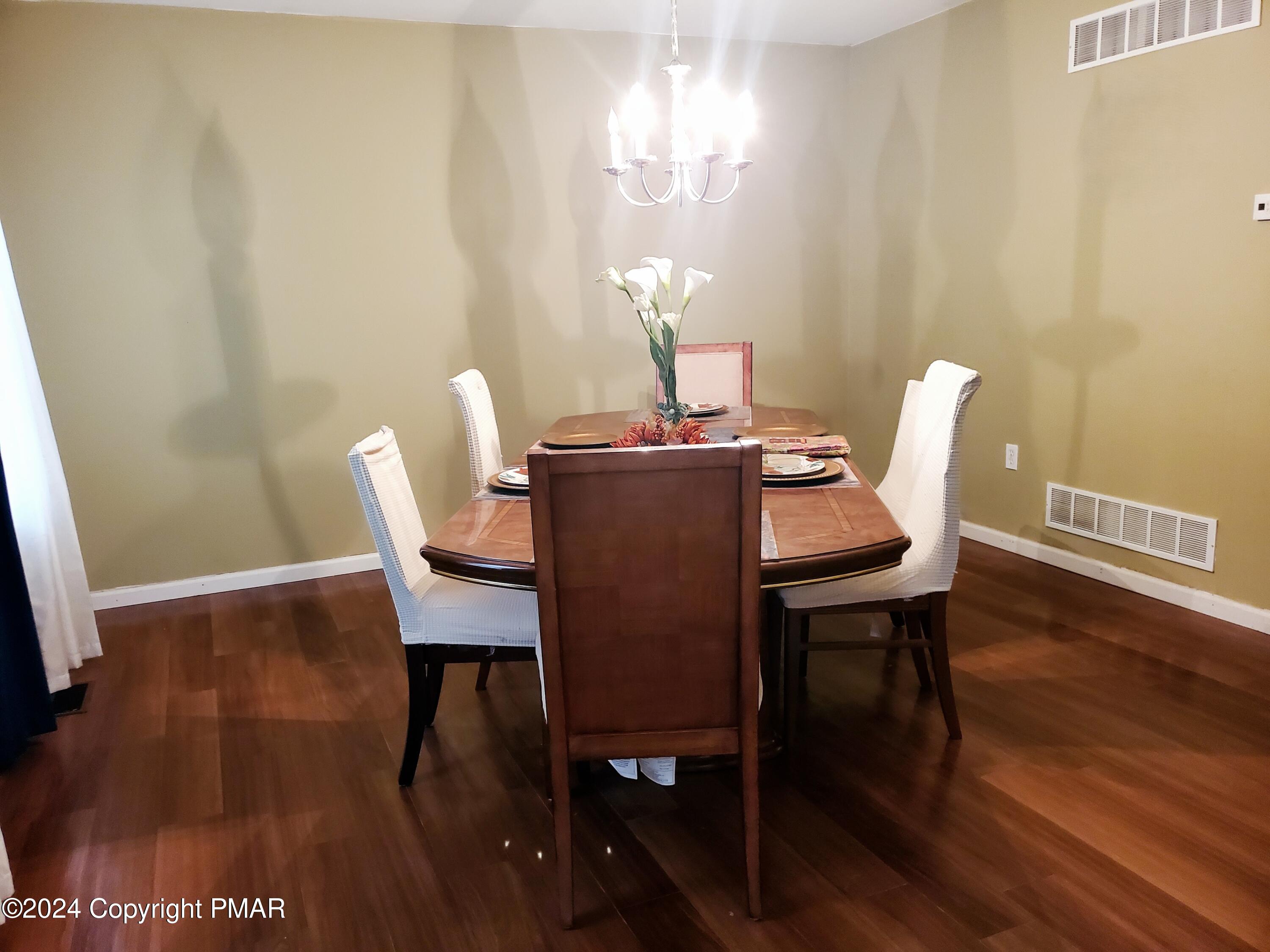 1102 Steele Circle Bushkill, PA 18324 - Photo 4 of 23 a dining room with furniture and wooden floor