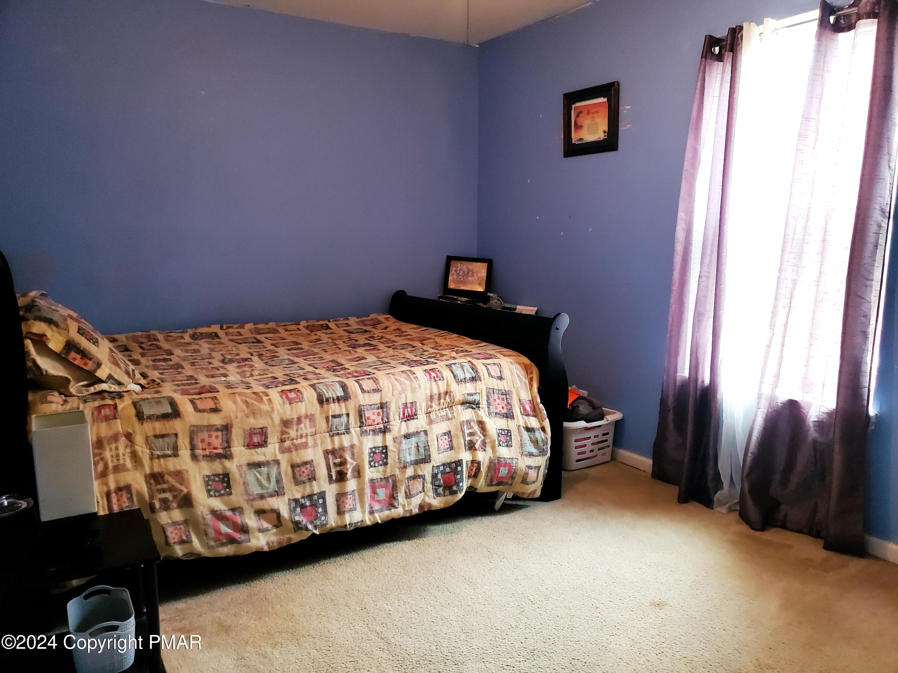 1102 Steele Circle Bushkill, PA 18324 - Photo 10 of 23 a bedroom with a bed and a window