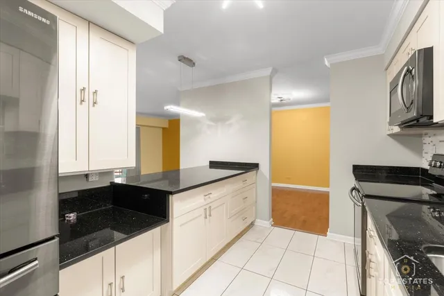 a kitchen with granite countertop a sink and a stove top oven