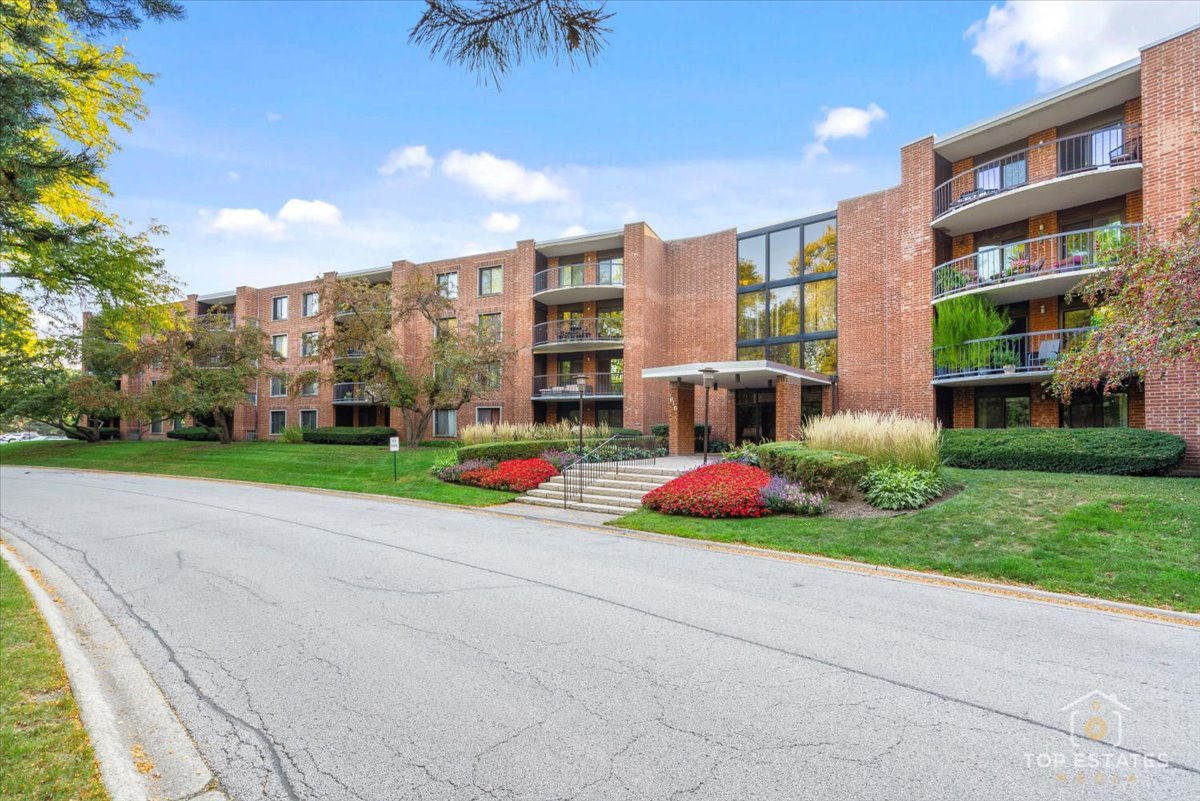 1615 East Central Road, Unit 218C Arlington Heights, IL 60005 - Photo 2 of 33 a view of building with yard