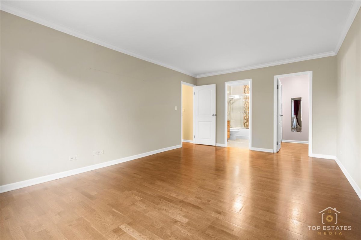 1615 East Central Road, Unit 218C Arlington Heights, IL 60005 - Photo 23 of 33 a view of an empty room with glass door