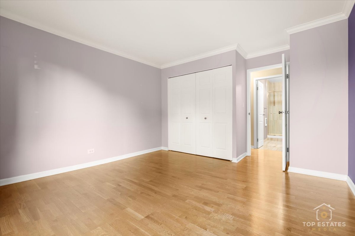 1615 East Central Road, Unit 218C Arlington Heights, IL 60005 - Photo 27 of 33 a view of an empty room with wooden floor