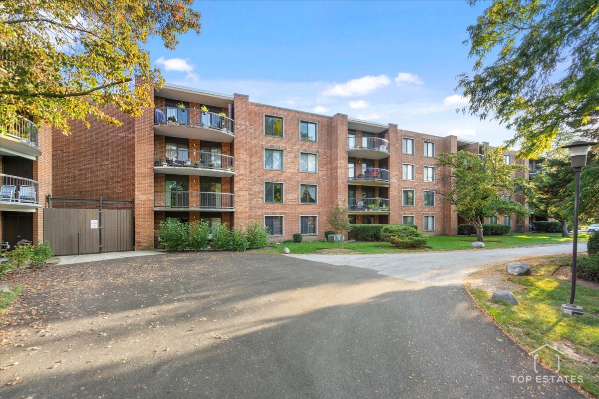 1615 East Central Road, Unit 218C Arlington Heights, IL 60005 - Photo 31 of 33 a view of a building with a yard