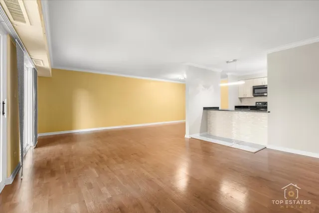 a view of a kitchen with a sink and a refrigerator