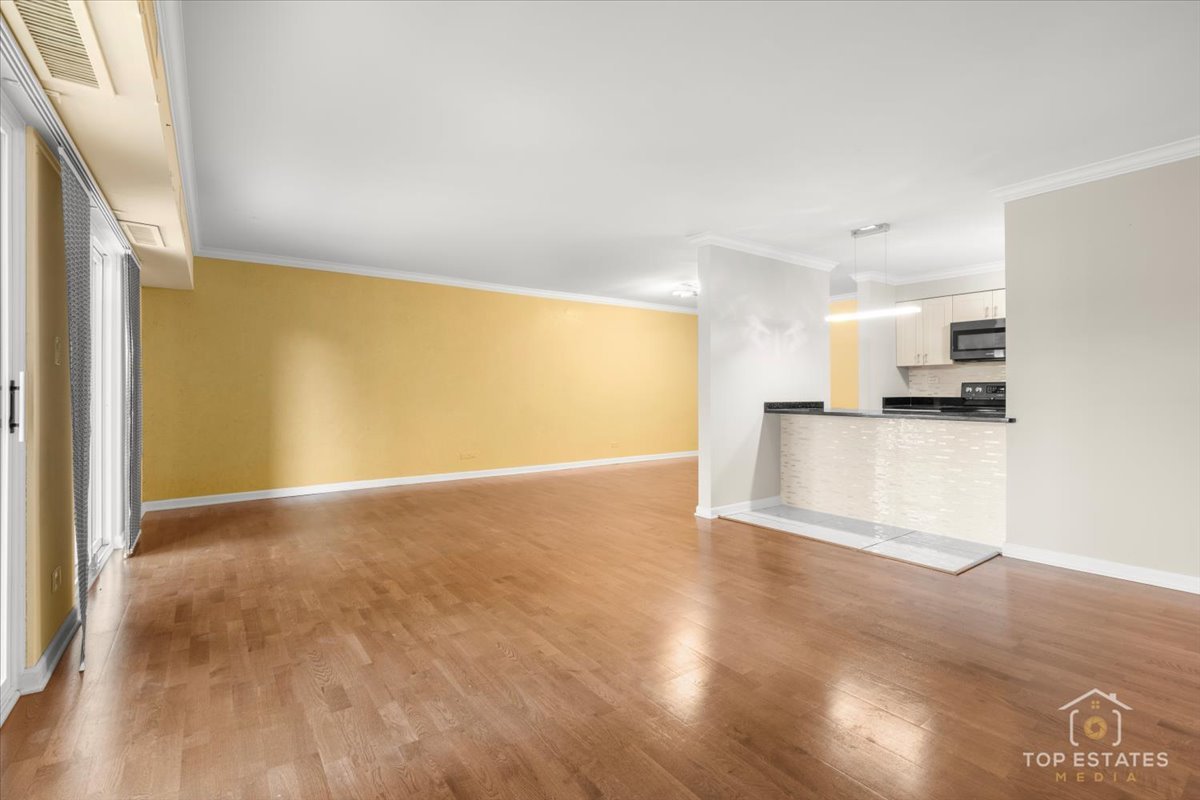 1615 East Central Road, Unit 218C Arlington Heights, IL 60005 - Photo 7 of 33 a view of a kitchen with a sink and a refrigerator