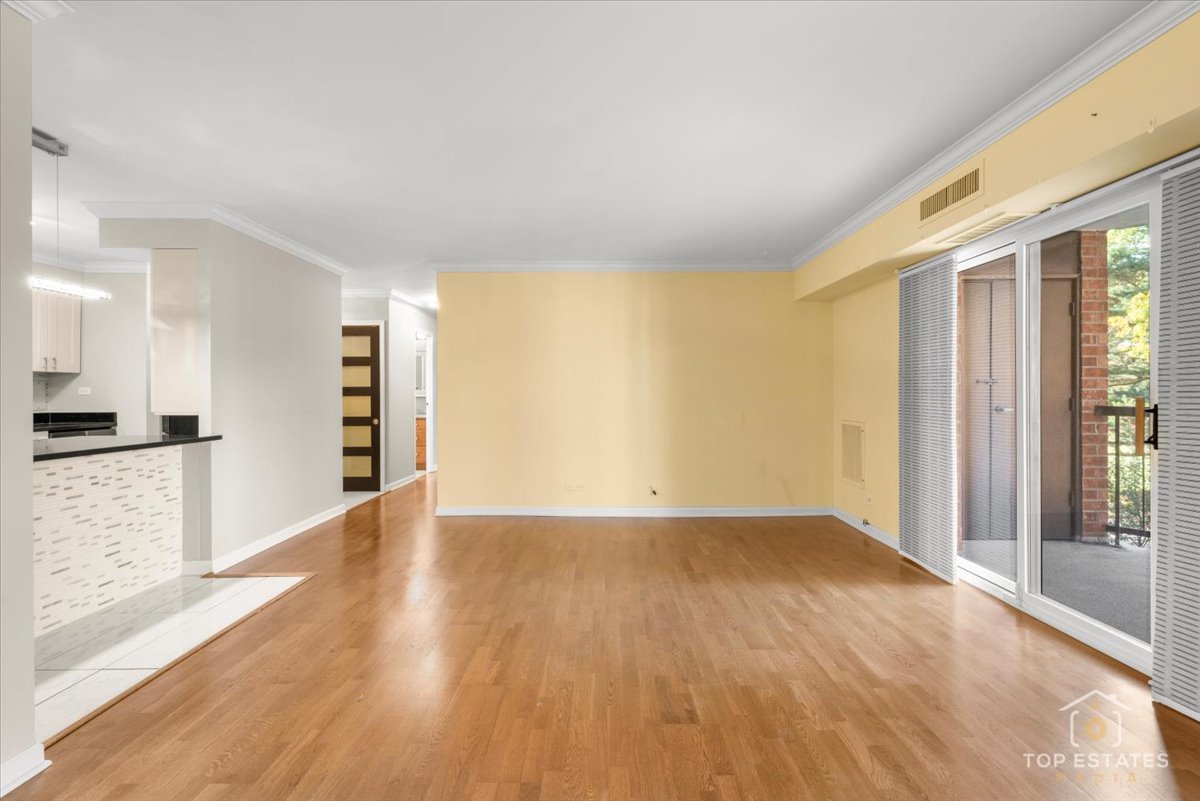 1615 East Central Road, Unit 218C Arlington Heights, IL 60005 - Photo 8 of 33 wooden floor in an empty room with a window