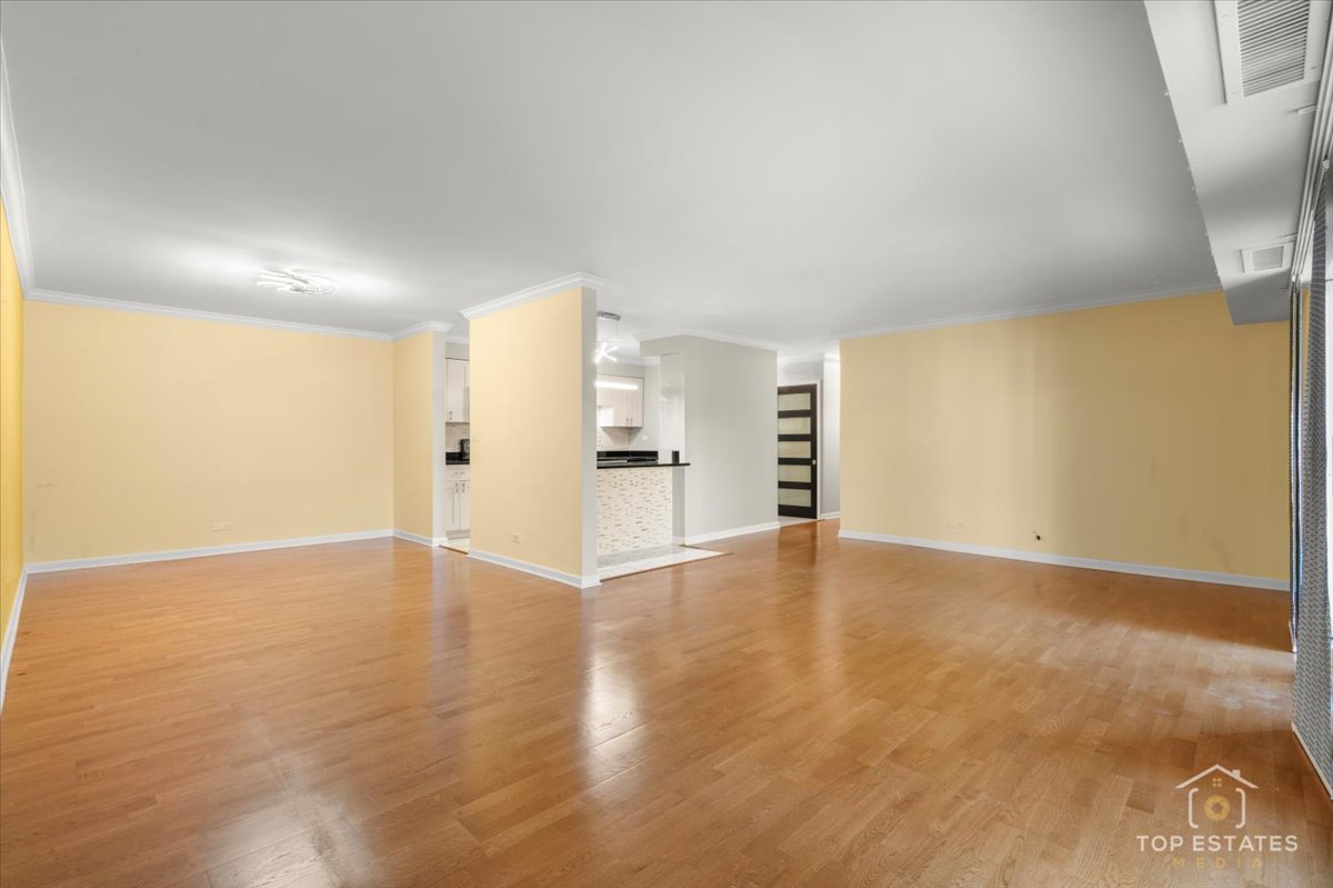 1615 East Central Road, Unit 218C Arlington Heights, IL 60005 - Photo 10 of 33 an empty room with wooden floor and windows