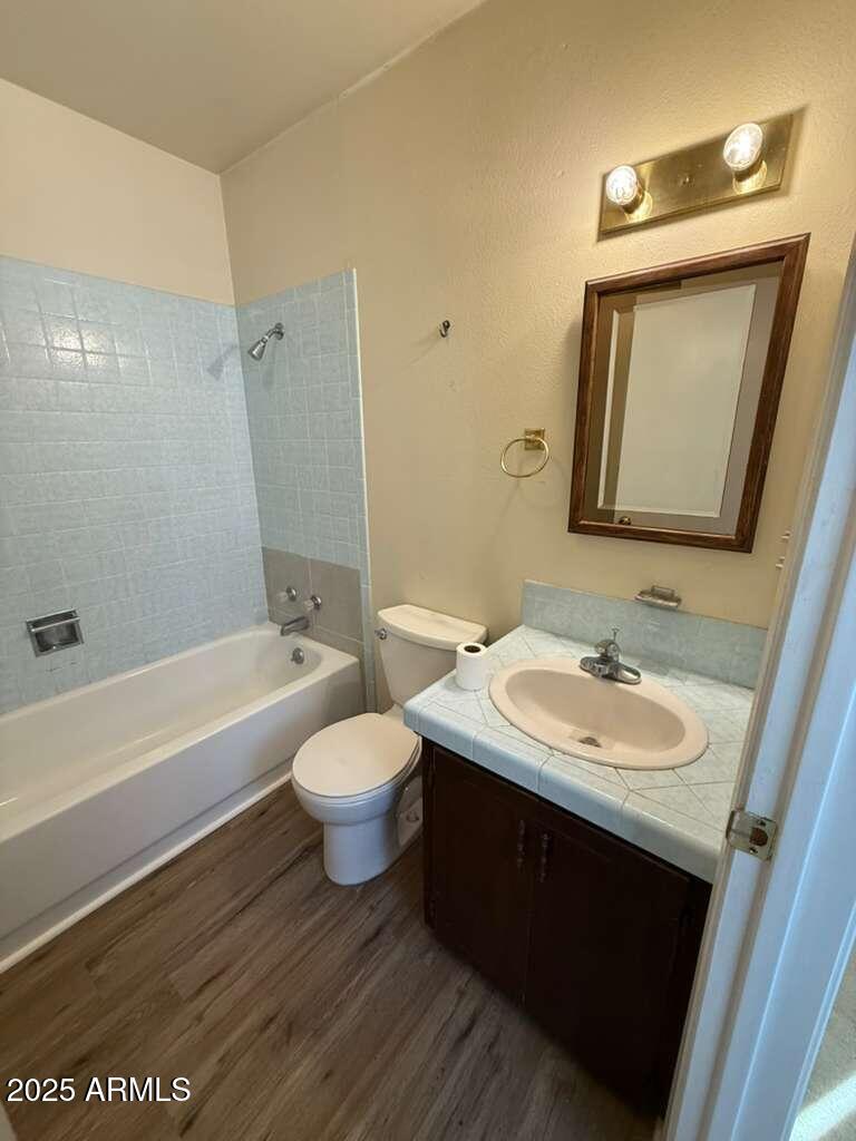 830 East 9th Street, Unit 1 Douglas, AZ 85607 - Photo 14 of 22 a bathroom with a toilet sink and mirror