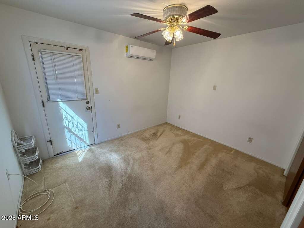 830 East 9th Street, Unit 1 Douglas, AZ 85607 - Photo 17 of 22 an empty room with a chandelier fan and windows