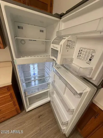 a view of a hallway with wooden floor and entryway