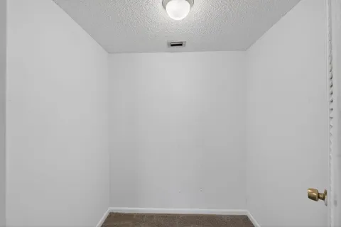 a view of an empty room with a floor to ceiling window