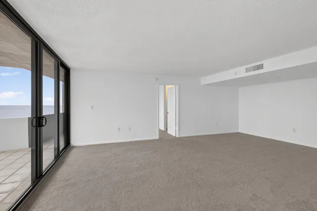 a view of an empty room with a large window