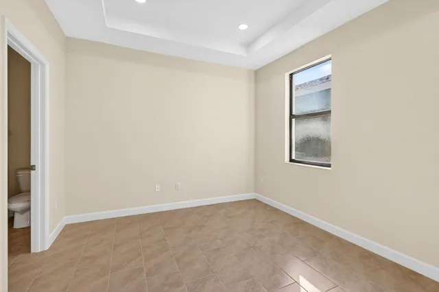 an empty room with windows and closet