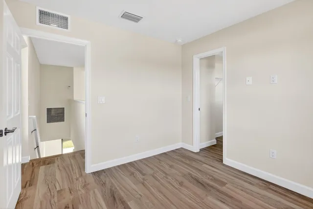 a bedroom with a bed and a painting on the wall