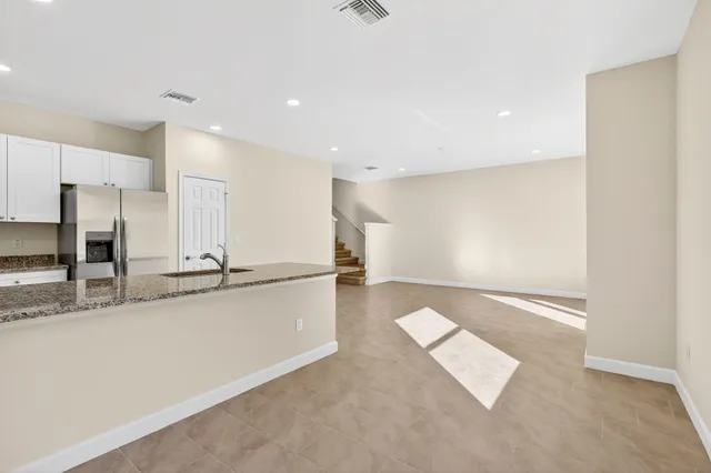 a view of a kitchen with a sink and a counter top space