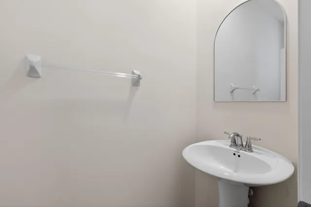 a bathroom with a sink a mirror and shower