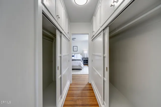 a view of a hallway with a livingroom and furniture