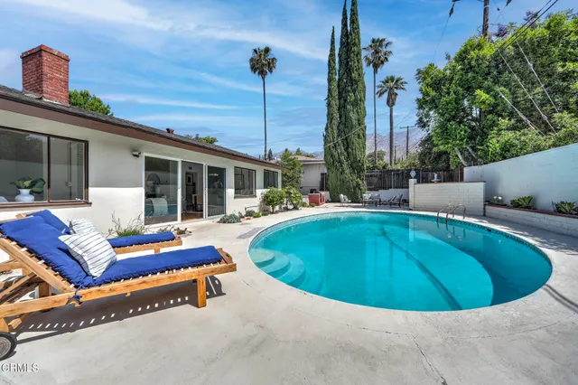a swimming pool with outdoor seating yard and outdoor seating