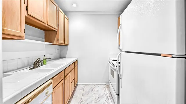 a kitchen with a sink a refrigerator and a window