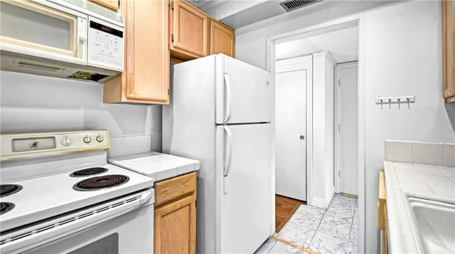 a kitchen with a refrigerator a stove a washer and dryer