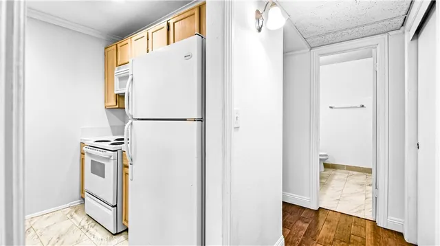 a white refrigerator freezer sitting inside of a kitchen