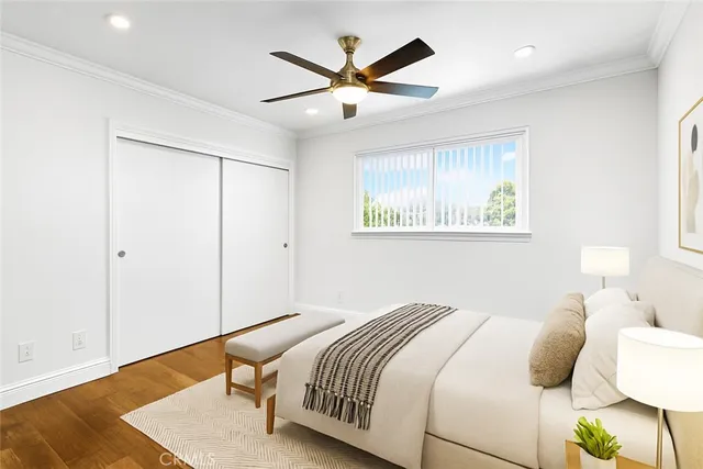 a bedroom with a bed and a ceiling fan