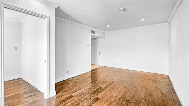 a view of hallway with wooden floor