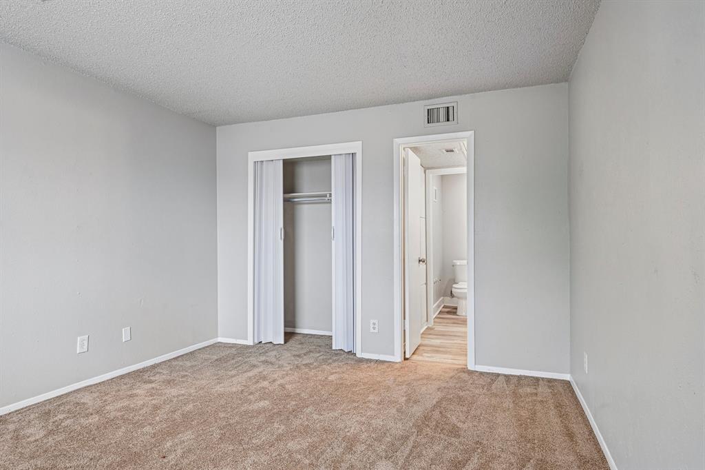 5534 Boca Raton Boulevard, Unit 292 Fort Worth, TX 76112 - Photo 20 of 31 an empty room with closet and mirror