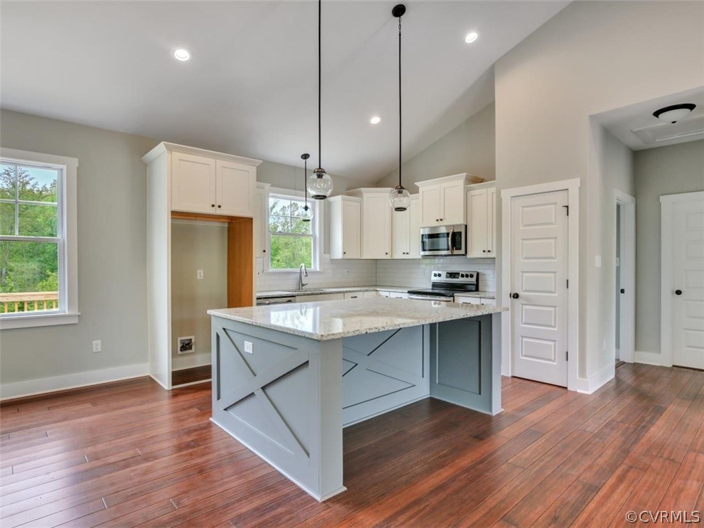 2120 The Grove Road Crewe, VA 23930 - Photo 7 of 28 a kitchen with stainless steel appliances granite countertop a sink a stove a refrigerator and island with wooden floor