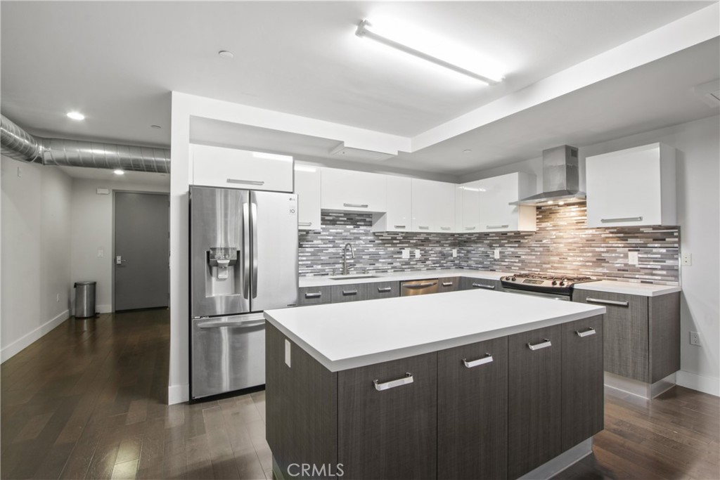 a kitchen with a sink a stove and refrigerator