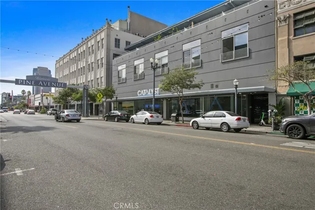 a view of a cars park in front of a building
