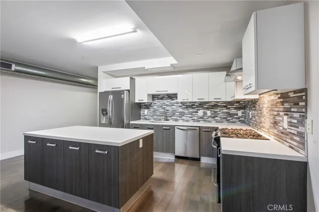 a kitchen with a stove top oven sink and cabinets