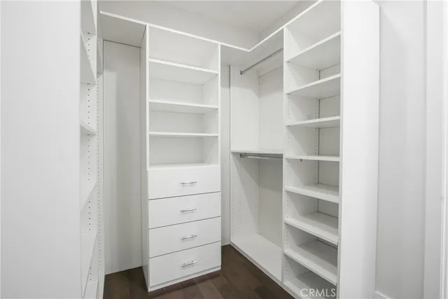 a view of walk in closet with empty racks