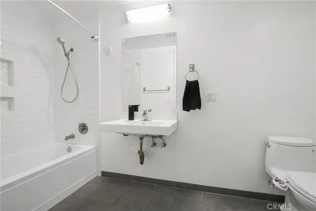 a bathroom with a sink a toilet and bathtub