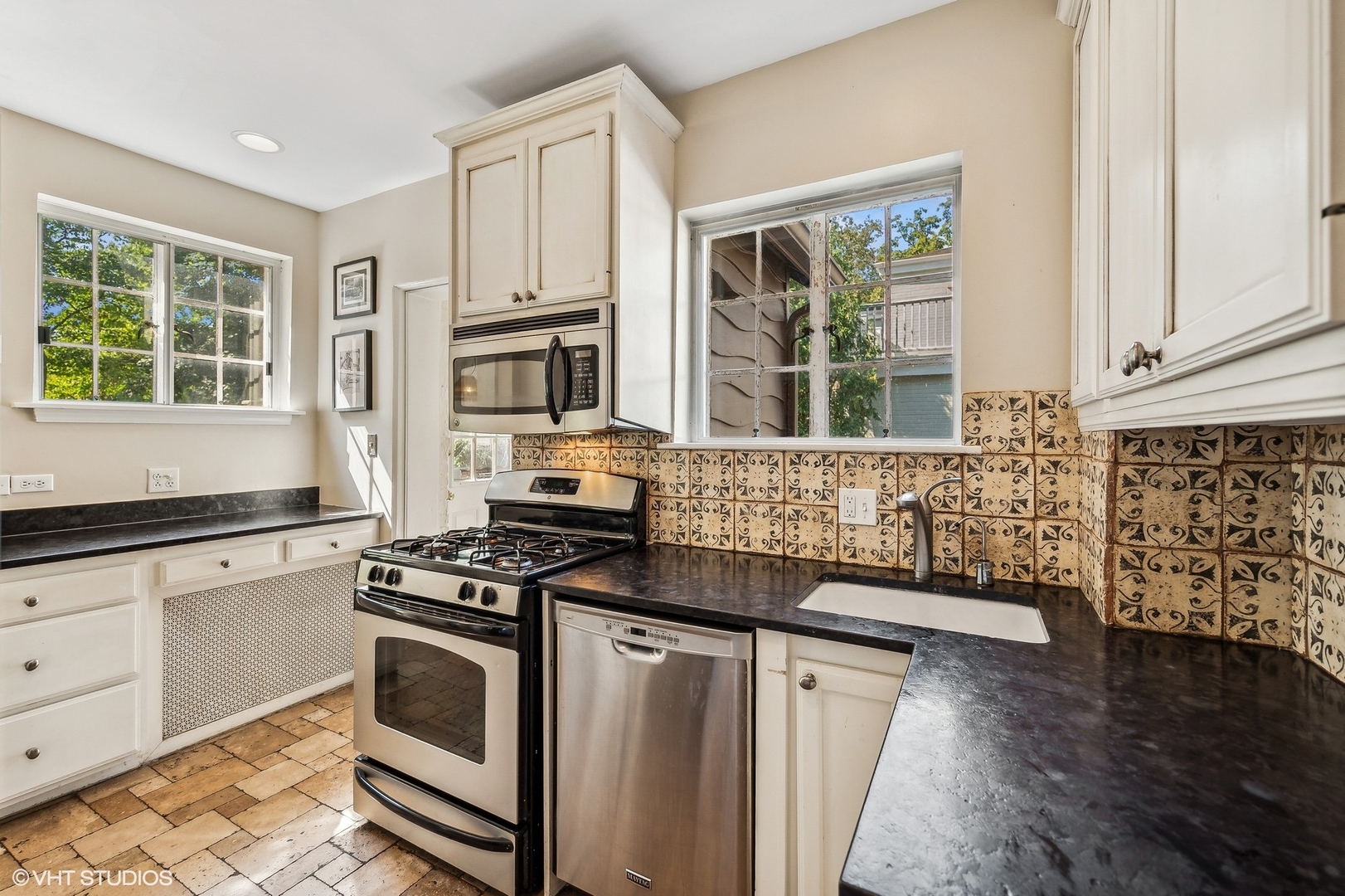 180 Randolph Street Glencoe, IL 60022 - Photo 12 of 36 a kitchen with granite countertop a stove a sink and a microwave