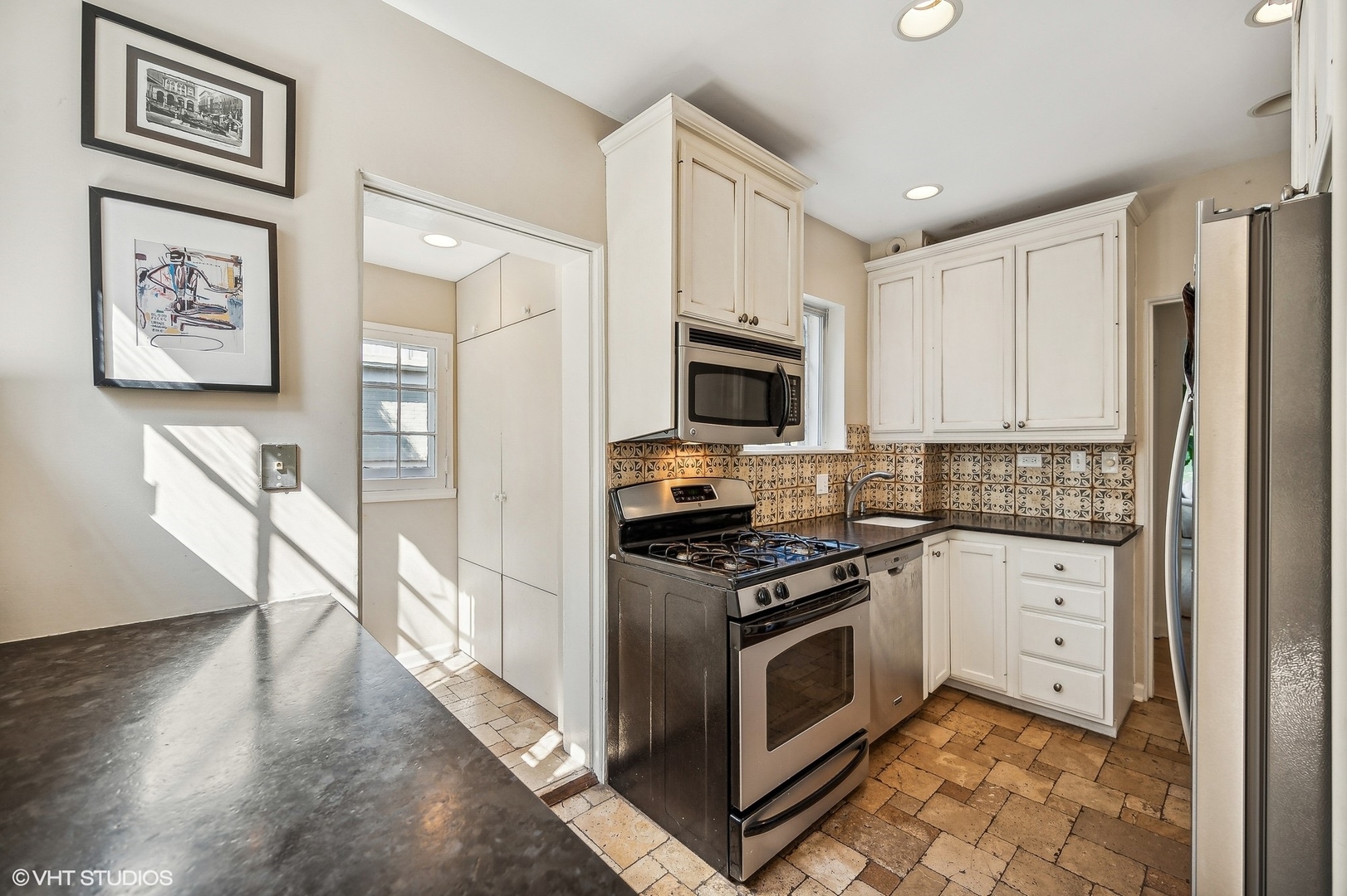 180 Randolph Street Glencoe, IL 60022 - Photo 13 of 36 a kitchen with stainless steel appliances a stove a refrigerator and a microwave