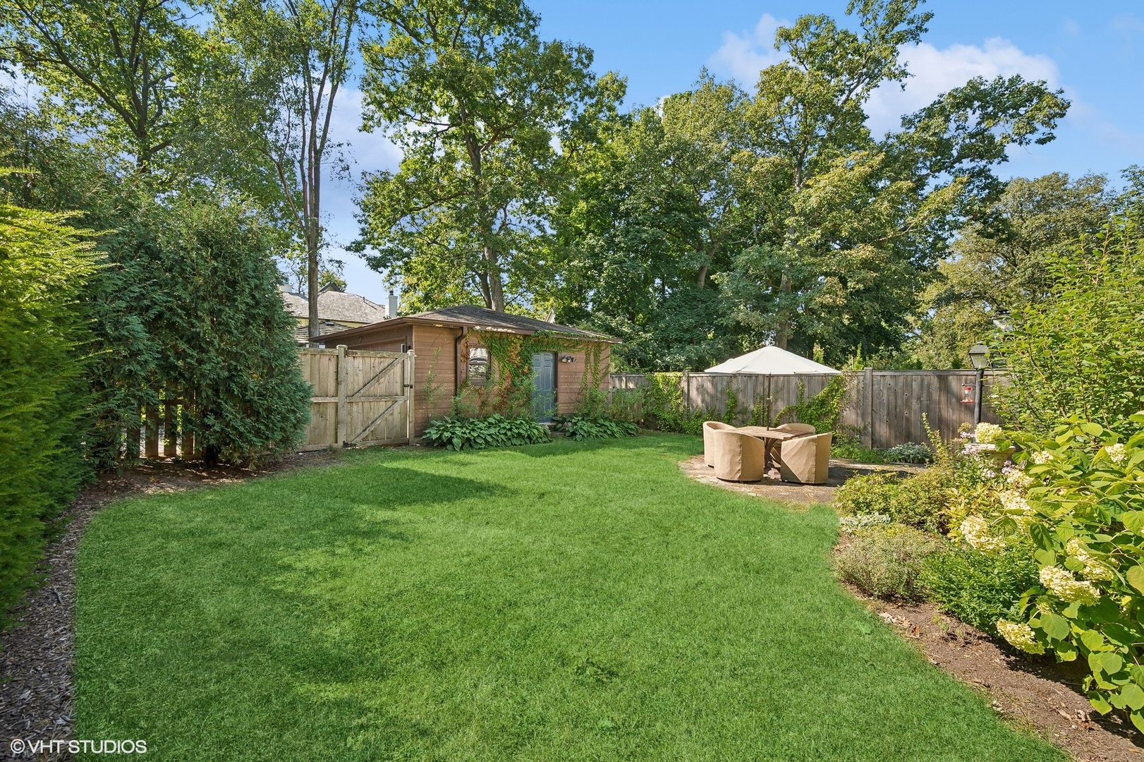 180 Randolph Street Glencoe, IL 60022 - Photo 30 of 36 a view of a house with backyard and sitting area