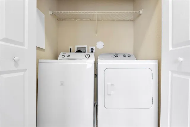 a view of a hallway with wooden floor and windows