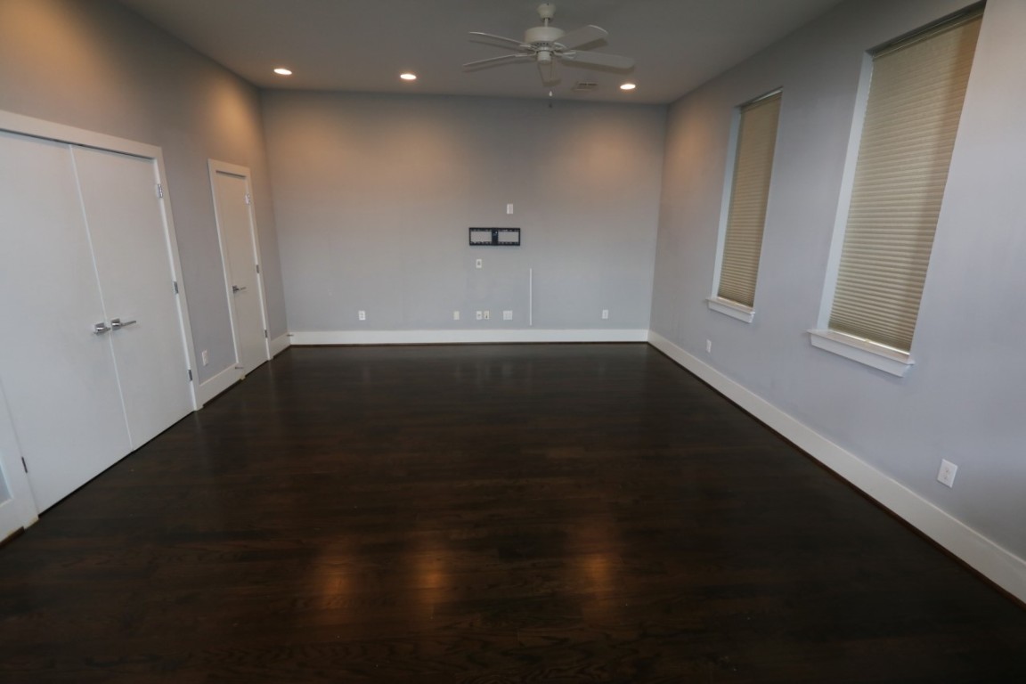 2103 Hadley Street Houston, TX 77003 - Photo 11 of 19 an empty room with wooden floor and windows