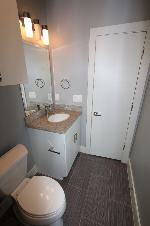 2103 Hadley Street Houston, TX 77003 - Photo 18 of 19 a bathroom with a toilet a sink and mirror