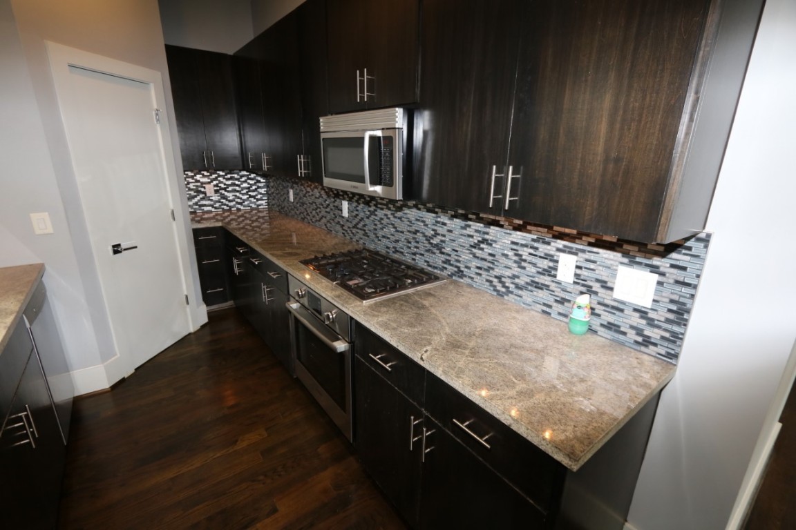 2103 Hadley Street Houston, TX 77003 - Photo 9 of 19 a kitchen with granite countertop a stove a sink and a refrigerator
