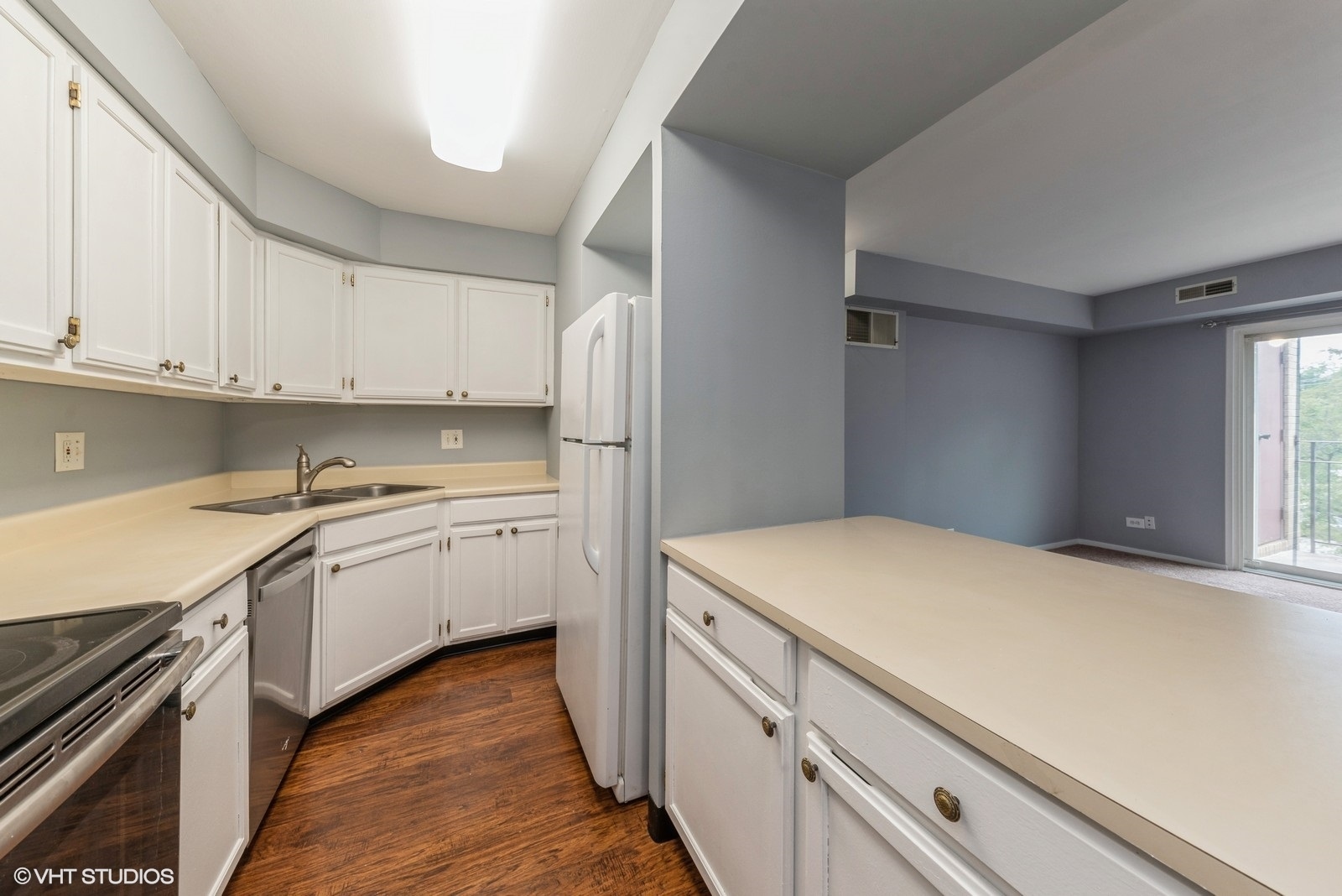 806 North River Road, Unit 3A Mount Prospect, IL 60056 - Photo 10 of 11 a kitchen with granite countertop white cabinets and white appliances