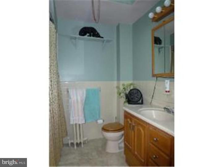 7028 Cresheim Road Philadelphia, PA 19119 - Photo 18 of 23 a bathroom with a toilet a sink and mirror
