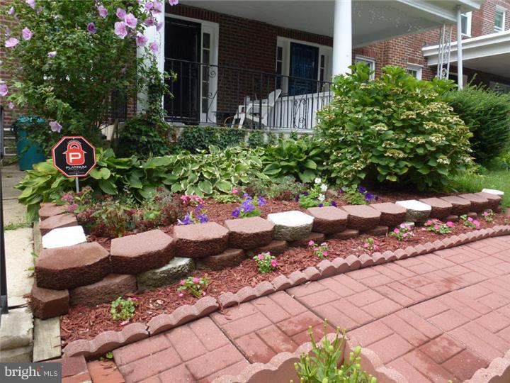 7028 Cresheim Road Philadelphia, PA 19119 - Photo 22 of 23 a bunch of flowers in front of a house