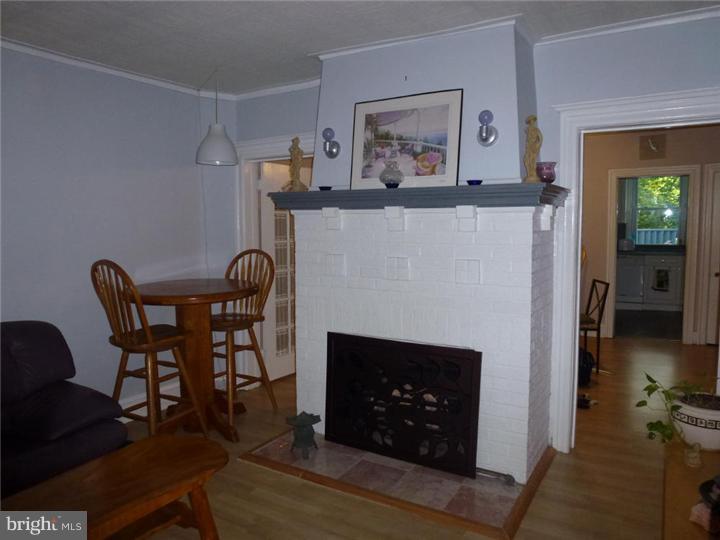 7028 Cresheim Road Philadelphia, PA 19119 - Photo 4 of 23 a living room with furniture and a fireplace