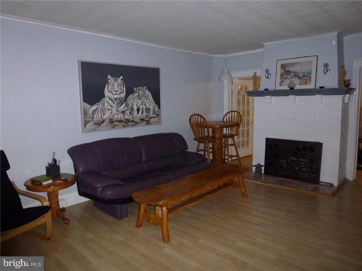 7028 Cresheim Road Philadelphia, PA 19119 - Photo 6 of 23 a living room with furniture and a fireplace