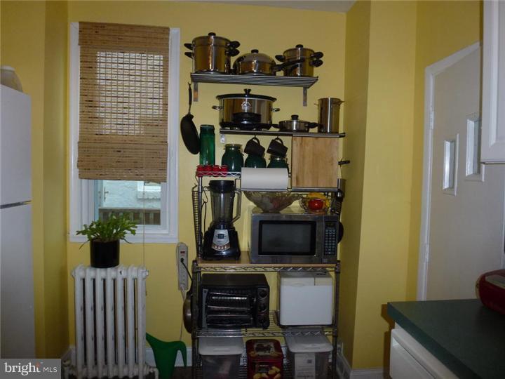 7028 Cresheim Road Philadelphia, PA 19119 - Photo 10 of 23 a kitchen with stainless steel appliances a stove a microwave a refrigerator and cabinets